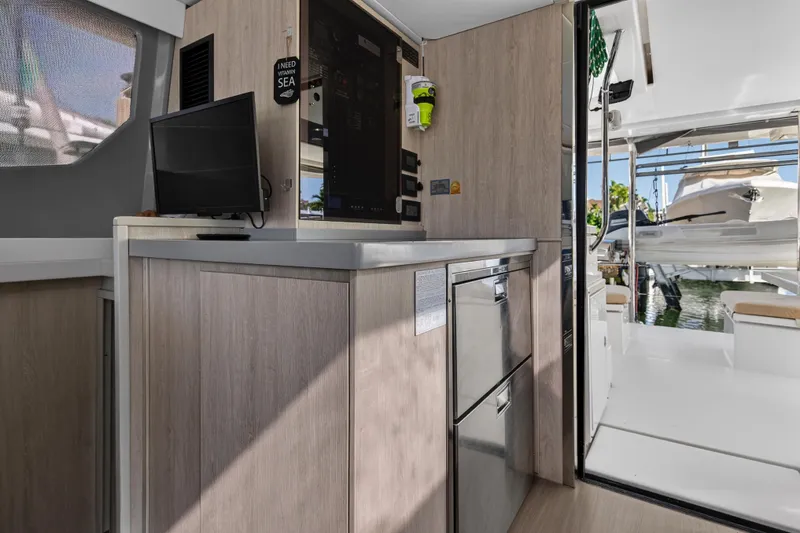 Slide: The Image of Interior of 2019 Leopard 45 yacht with modern kitchen and outdoor view. - 84