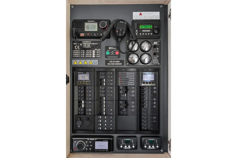 Slide: The Image of Electrical control panel of a 2019 Leopard 45 yacht with various gauges and switches. - 86