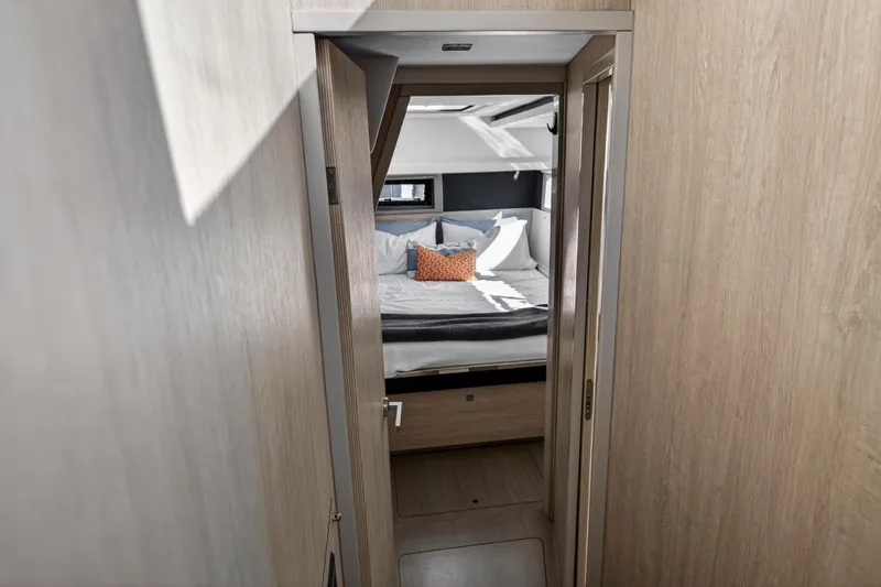 Slide: The Image of Interior view of a 2019 Leopard 45 yacht cabin with bed and pillows. - 99