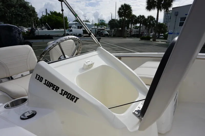 Slide: The Image of 2026 Boston Whaler 130 Super Sport boat interior with open storage compartment. - 12