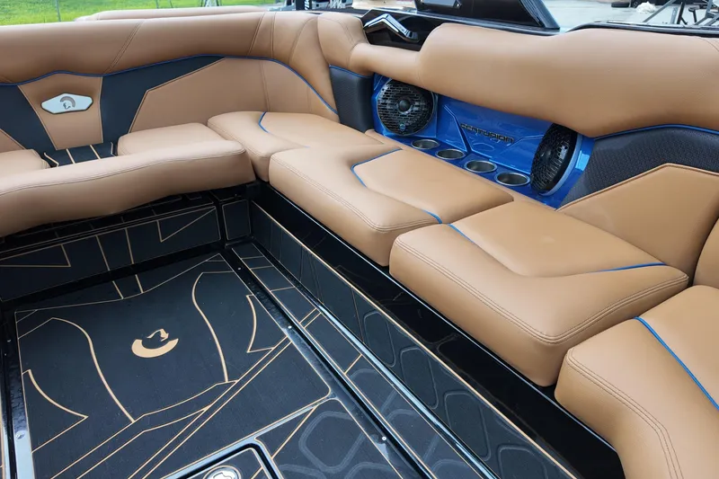 Slide: The Image of Luxurious interior of 2025 Centurion Fe23 boat with tan leather seating and blue accents. - 13