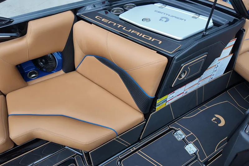 Slide: The Image of 2025 Centurion Fe23 boat interior with tan leather seats and modern design. - 14