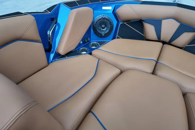Slide: The Image of Luxurious interior of 2025 Centurion Fe23 boat with tan seating and blue accents. - 16