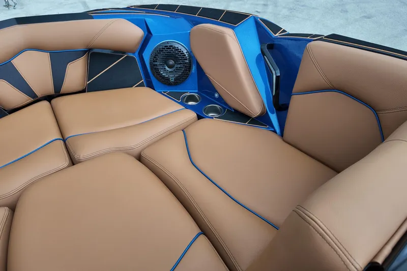 Slide: The Image of Luxurious interior of 2025 Centurion Fe23 boat with tan leather seating and blue accents. - 17