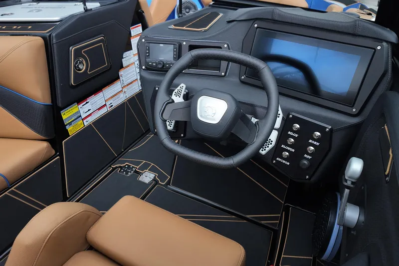 Slide: The Image of Interior of 2025 Centurion Fe23 boat with modern dashboard and steering wheel. - 18