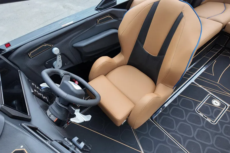 Slide: The Image of 2025 Centurion Fe23 boat interior with tan leather seat and modern steering wheel. - 20