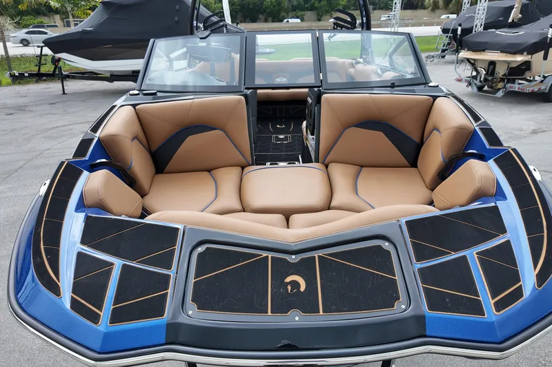 Slide: The Image of 2025 Centurion Fe23 boat with luxurious tan seating and sleek blue-black design. - 3