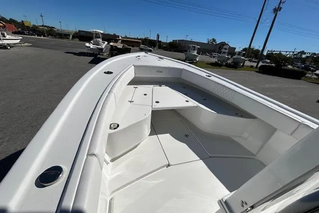 Slide: The Image of 2026 Pair Customs 24 Center Console DV Offshore boat, spacious deck view, parked outdoors. - 11