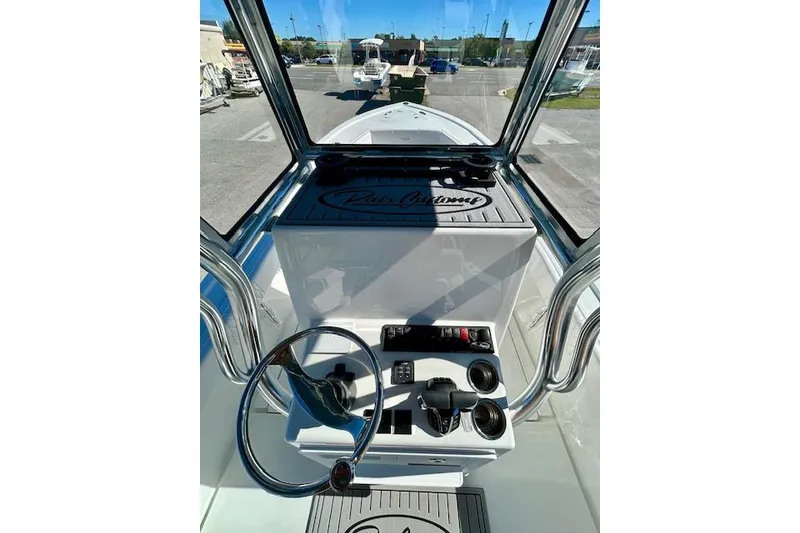 Slide: The Image of 2026 Pair Customs 24 Center Console DV Offshore boat interior with steering wheel and controls. - 16