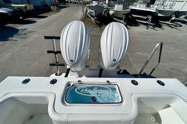 Slide: The Image of 2026 Pair Customs 24 Center Console DV Offshore boat with dual engines, docked outdoors. - 19