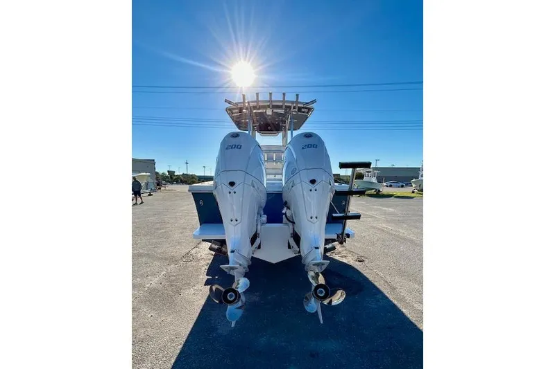 Slide: The Image of 2026 Pair Customs 24 Center Console DV Offshore boat with dual engines, sunlit background. - 5