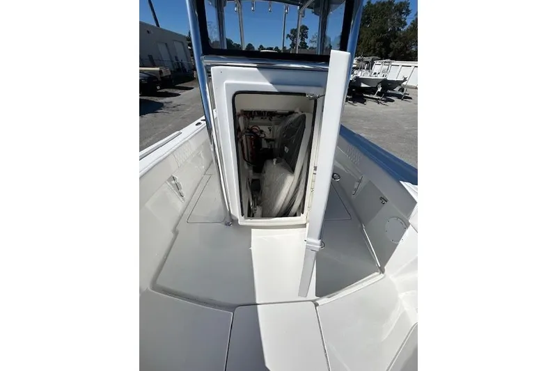 Slide: The Image of 2026 Pair Customs 24 Center Console DV Offshore boat interior, showcasing storage compartment. - 9