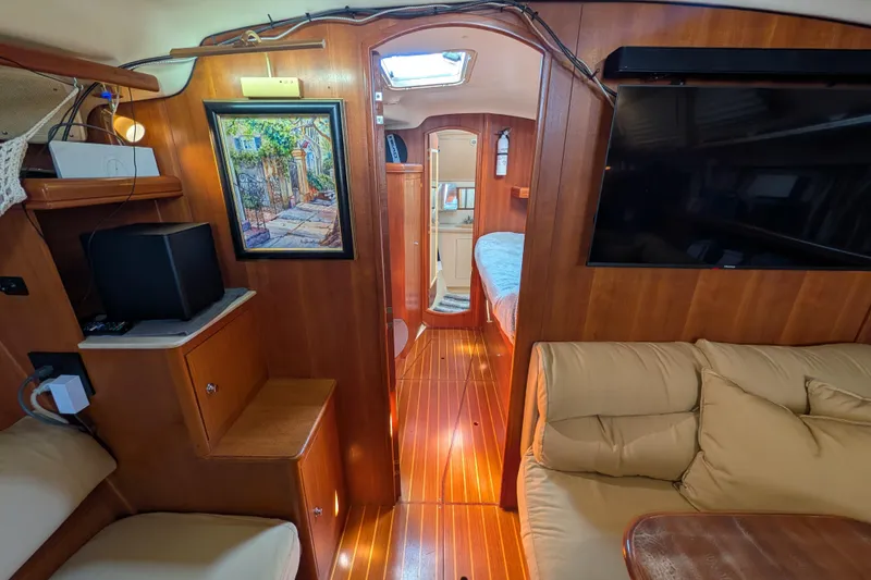 Slide: The Image of Interior of 2002 Hunter 450 Passage yacht with cozy seating and wooden finishes. - 26