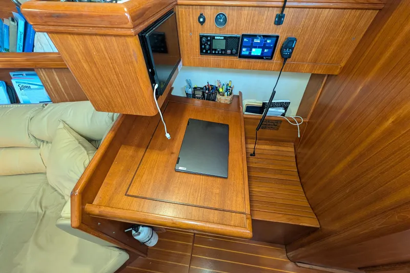 Slide: The Image of Navigation station in 2002 Hunter 450 Passage yacht with wooden desk and electronics. - 34