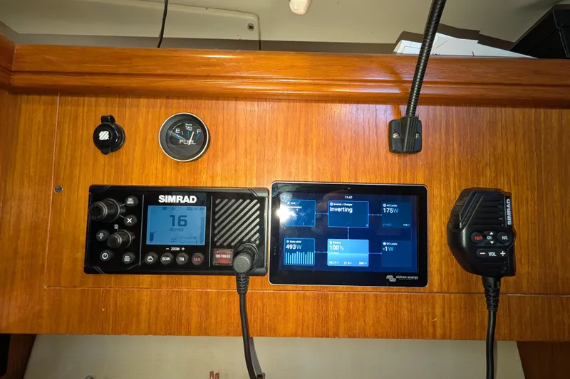 Slide: The Image of Control panel of a 2002 Hunter 450 Passage yacht with Simrad and Victron Energy displays. - 35
