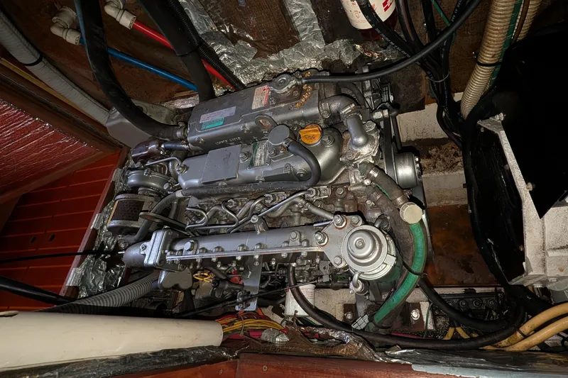 Slide: The Image of Engine compartment of a 2002 Hunter 450 Passage sailboat, showcasing intricate mechanical components. - 42
