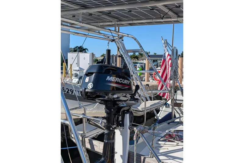 Slide: The Image of Outboard motor on 2002 Hunter 450 Passage sailboat, docked with American flag. - 45