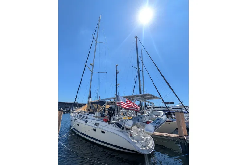 Slide: The Image of Sailboat Hunter 450 Passage 2002 docked under bright sun with American flag. - 46