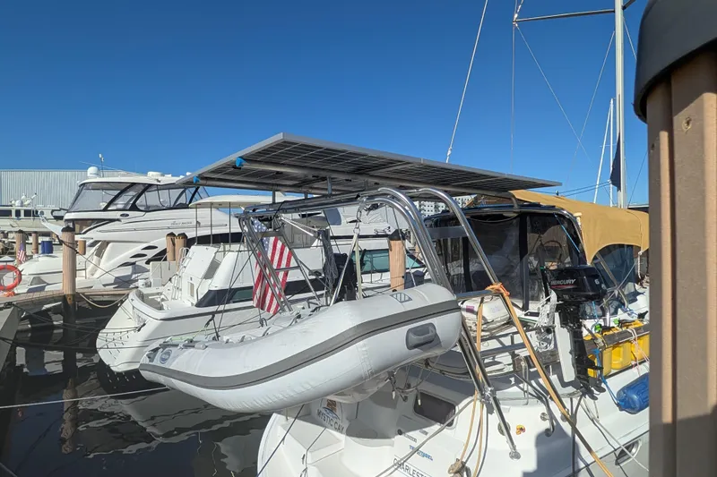 Slide: The Image of 2002 Hunter 450 Passage sailboat docked with solar panels and inflatable dinghy. - 6