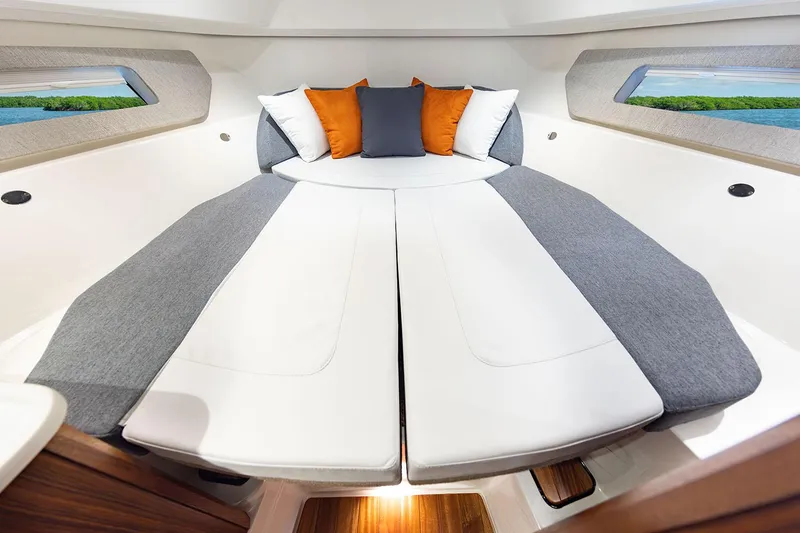 Slide: The Image of Manufacturer Provided Image: 2025 Pursuit OS 325 Offshore cabin with modern bedding and scenic windows. - 21