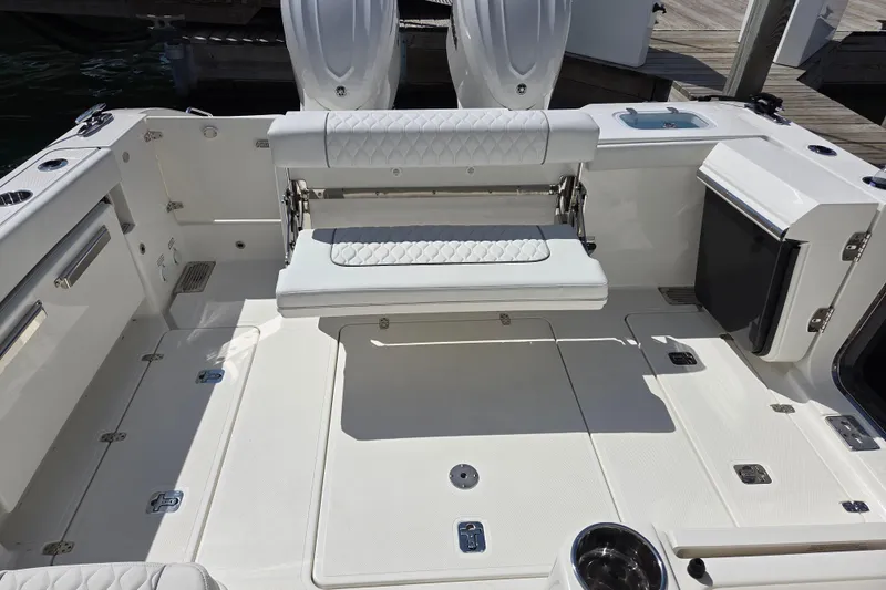 Slide: The Image of 2026 Pursuit OS 325 Offshore boat deck with foldable seating and storage compartments. - 23