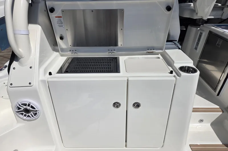 Slide: The Image of 2026 Pursuit OS 325 Offshore boat galley with storage and speaker. - 24