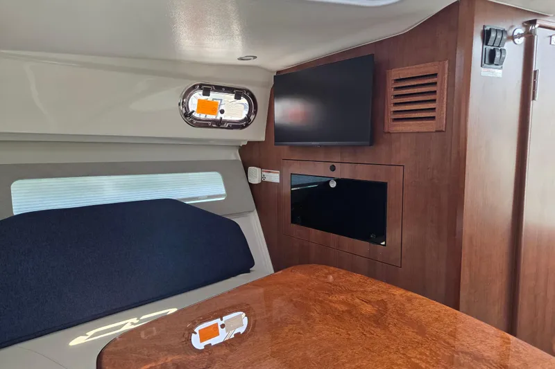 Slide: The Image of Interior of 2026 Pursuit OS 325 Offshore boat with wood finish and modern amenities. - 32