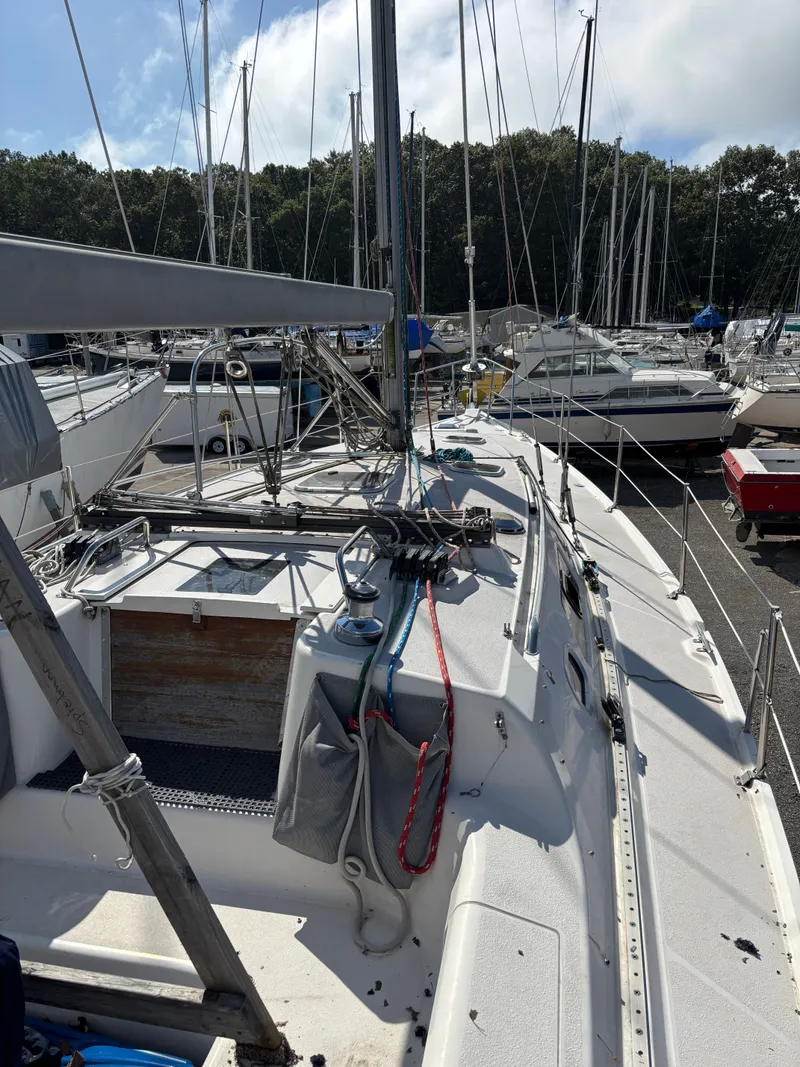 Slide: The Image of Catalina 380 sailboat from 2000 docked in a marina, surrounded by other boats. - 12