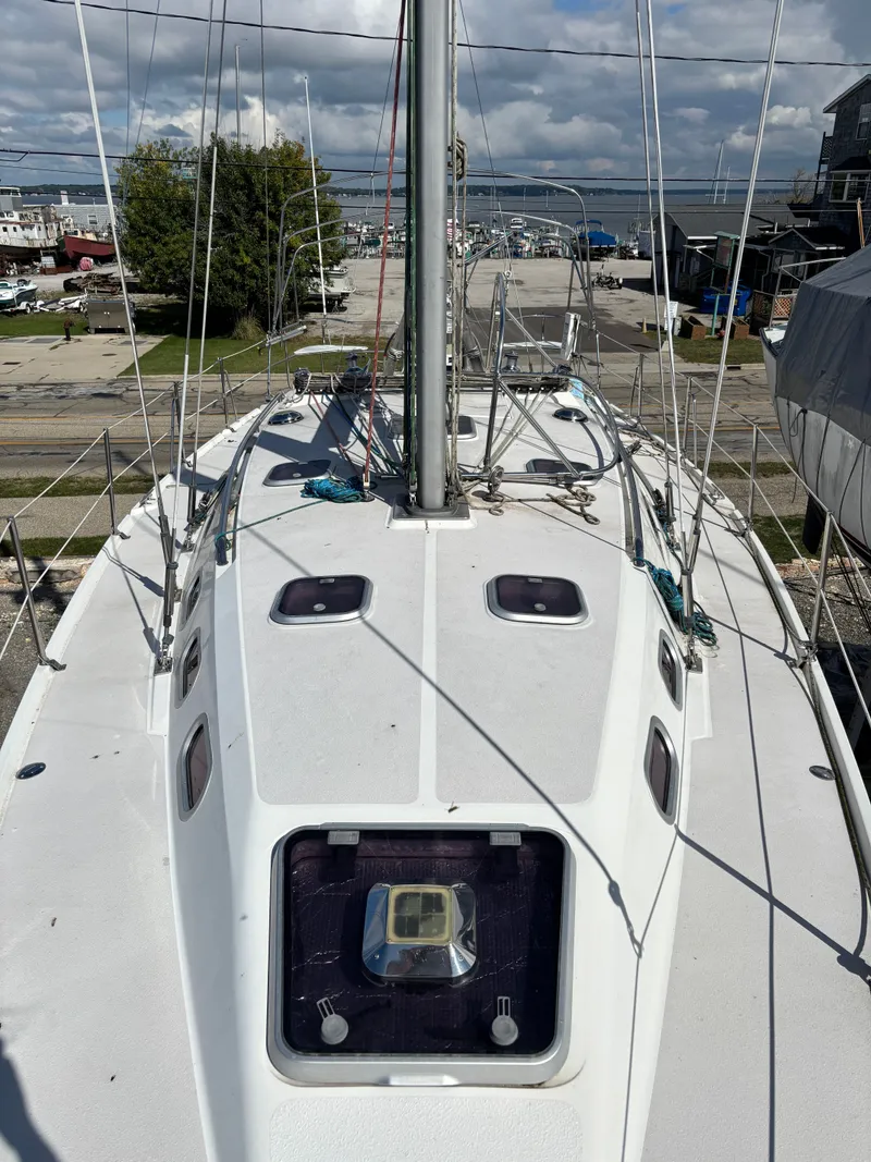 Slide: The Image of 2000 Catalina 380 sailboat deck view with marina background. - 17