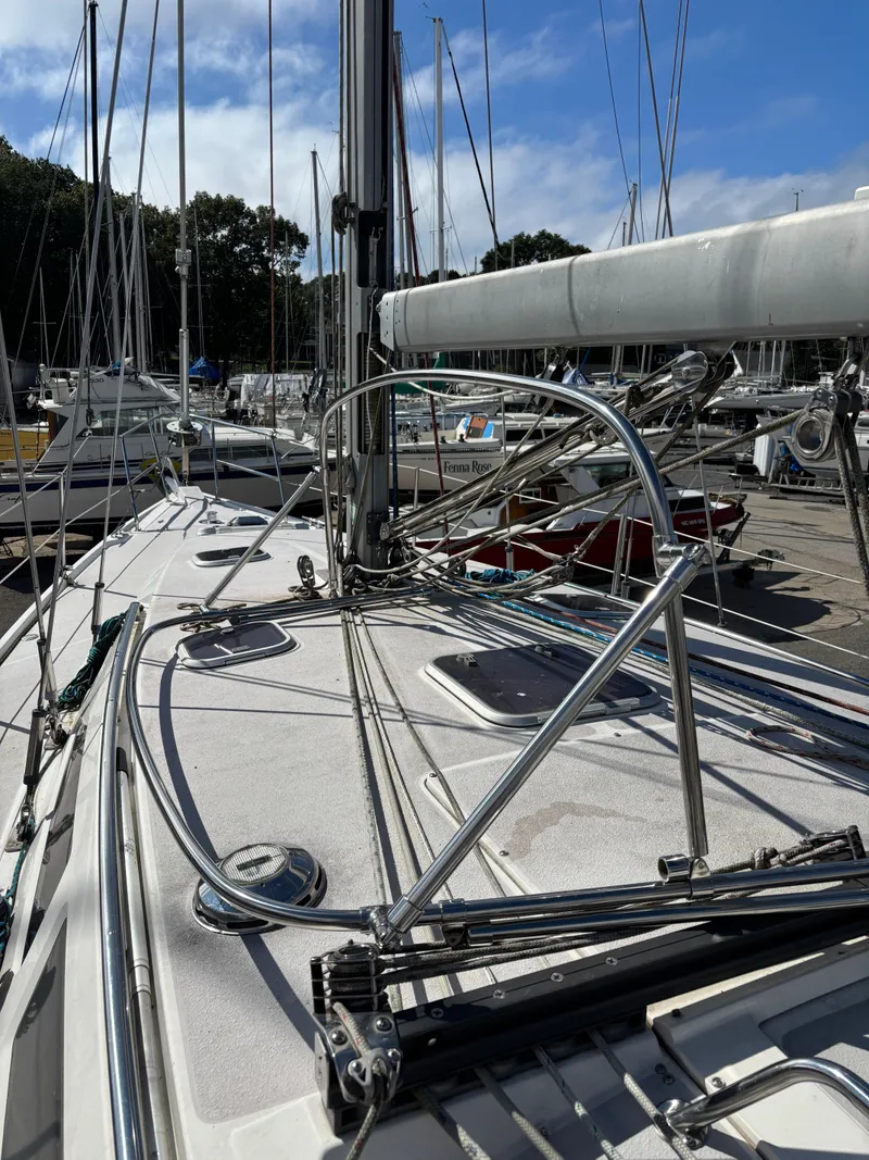 Slide: The Image of Sailboat deck of 2000 Catalina 380 in marina, featuring rigging and clear sky. - 20