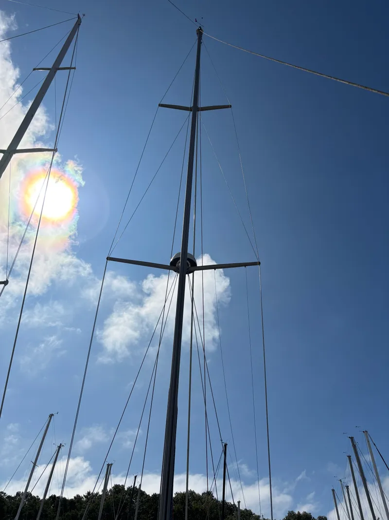 Slide: The Image of Tall sailboat mast of a 2000 Catalina 380 against a bright blue sky. - 21