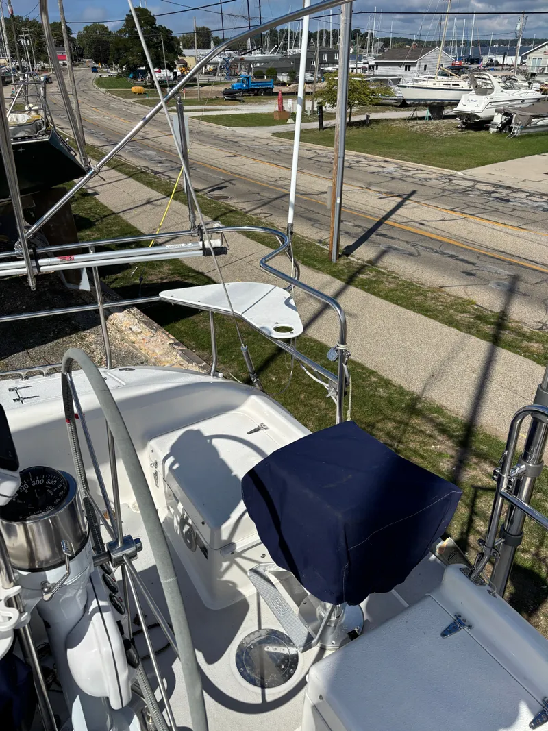 Slide: The Image of Deck view of a 2000 Catalina 380 sailboat in a marina setting. - 24