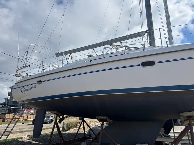 Slide: The Image of Catalina 380 sailboat from 2000 on stands, under a cloudy sky. - 3