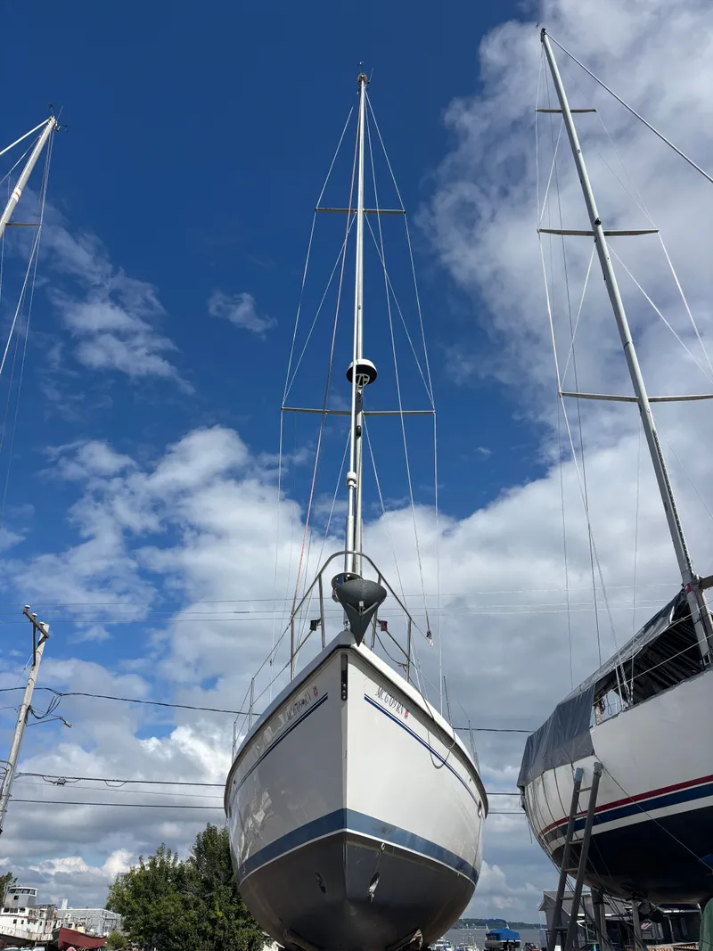 Slide: The Image of Catalina 380 sailboat from 2000 on land, under a clear blue sky. - 4