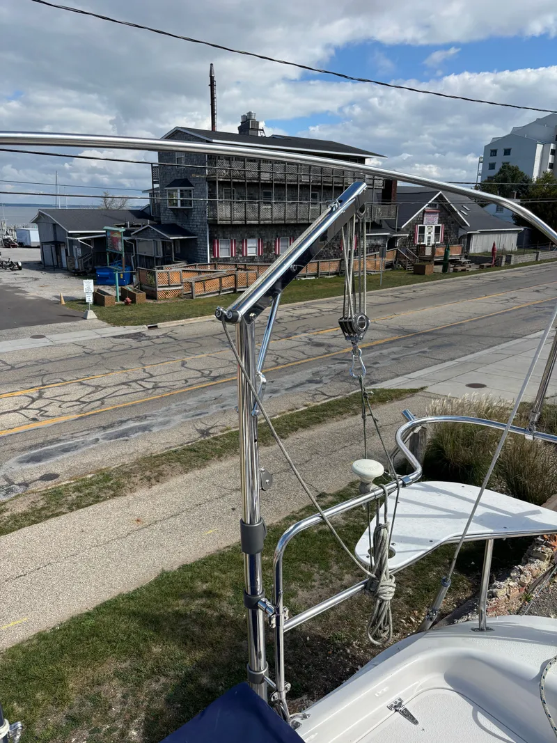 Slide: The Image of Catalina 380 sailboat docked near a rustic building, showcasing its stainless steel rigging. - 41