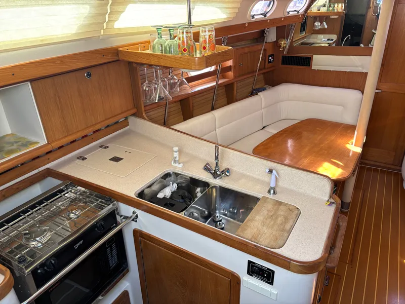Slide: The Image of Interior of 2000 Catalina 380 yacht with kitchen and dining area. - 46