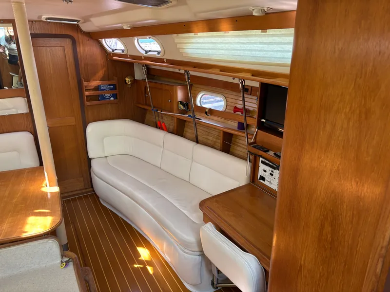 Slide: The Image of Interior of 2000 Catalina 380 sailboat with wooden finish and white seating. - 47