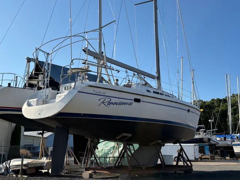 Slide: The Image of Catalina 380 sailboat from 2000 on dry dock, named "Renaissance," under clear blue sky. - 6