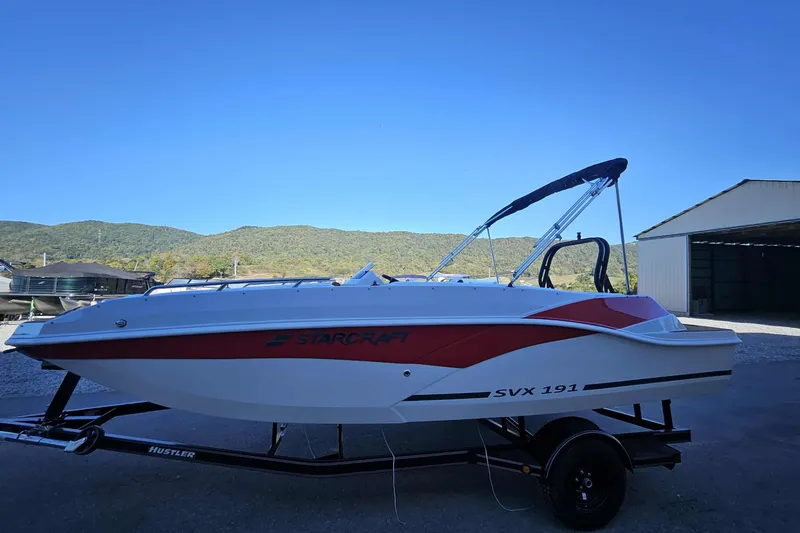 Slide: The Image of 2026 Starcraft SVX 191 OB boat on trailer, scenic mountain backdrop. - 12
