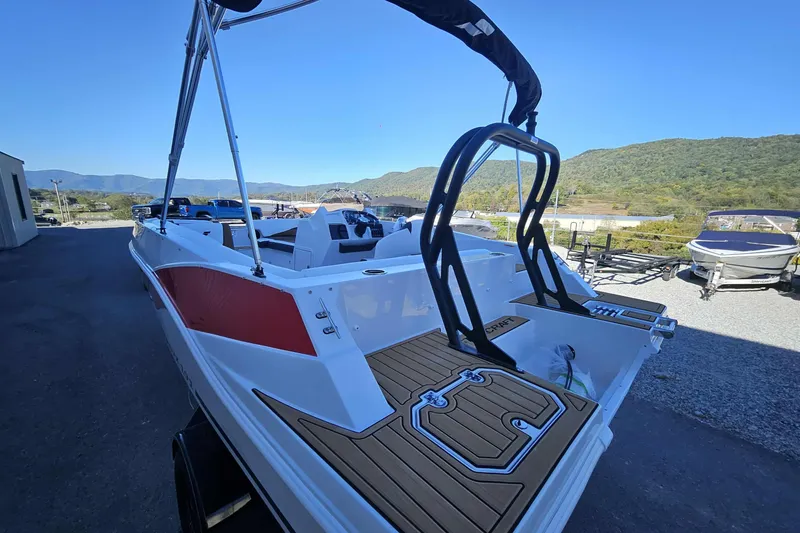 Slide: The Image of 2026 Starcraft SVX 191 OB boat with sleek design, docked outdoors, scenic mountain backdrop. - 13