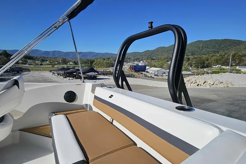 Slide: The Image of 2026 Starcraft SVX 191 OB boat interior with seating, scenic mountain backdrop. - 14