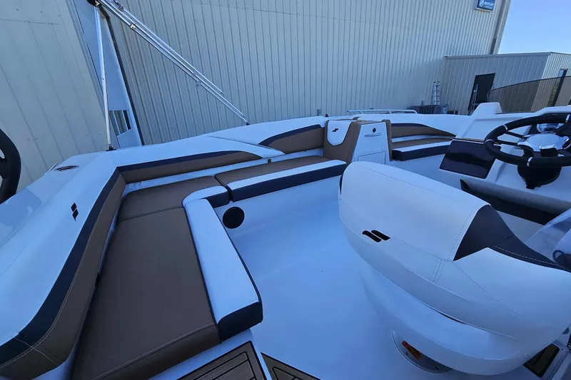 Slide: The Image of 2026 Starcraft SVX 191 OB boat interior with sleek seating and modern steering console. - 16