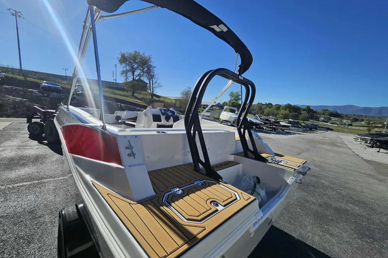Slide: The Image of 2026 Starcraft SVX 191 OB boat with sleek design and modern features in a sunny outdoor setting. - 2