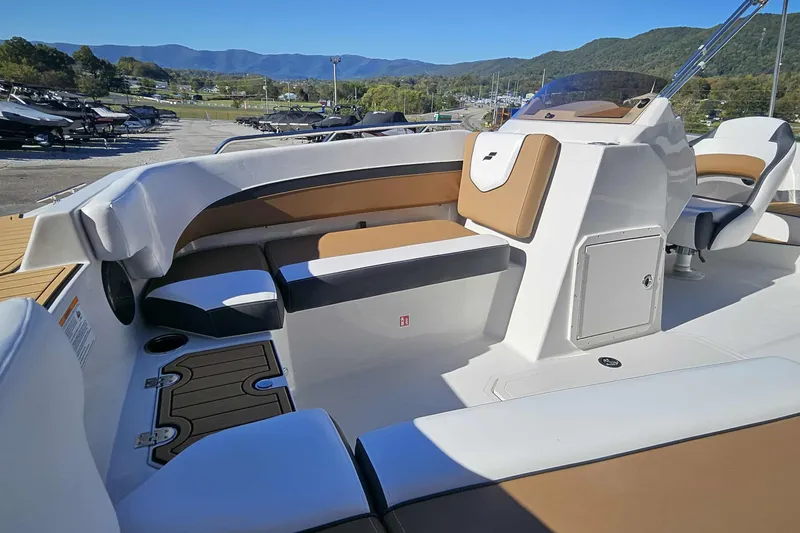 Slide: The Image of 2026 Starcraft SVX 191 OB boat interior with seating, console, and scenic mountain backdrop. - 5