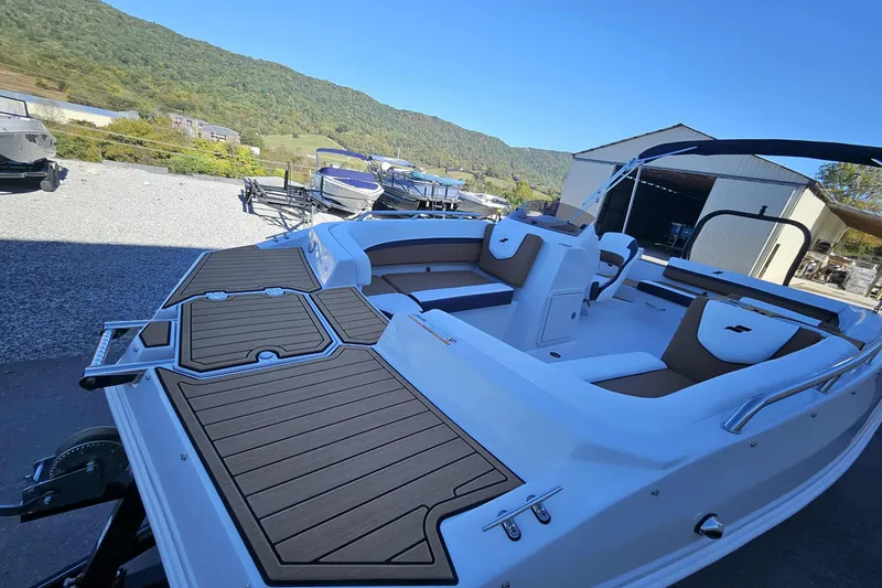 Slide: The Image of 2026 Starcraft SVX 191 OB boat with spacious seating and sleek design in a scenic outdoor setting. - 9