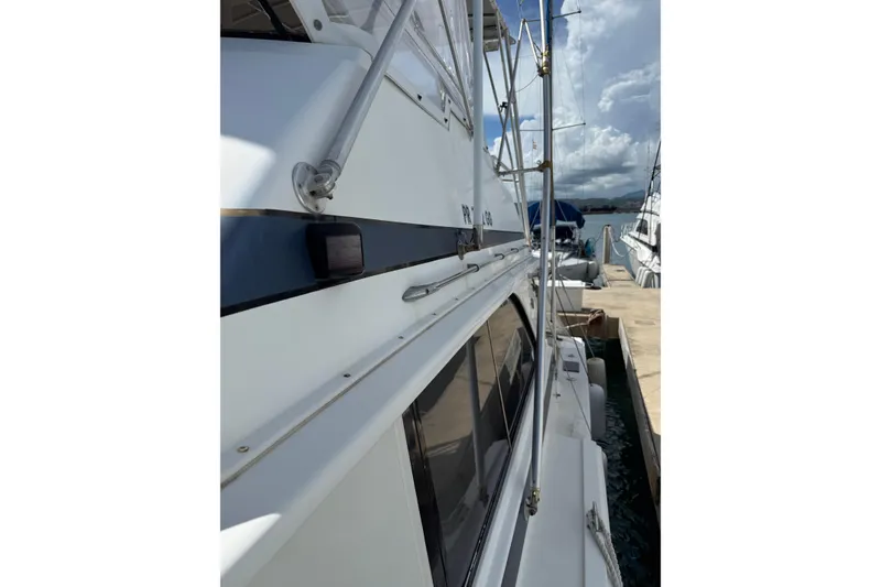 Slide: The Image of 1984 Bertram 46 Convertible yacht docked at marina, side view with clear skies. - 15