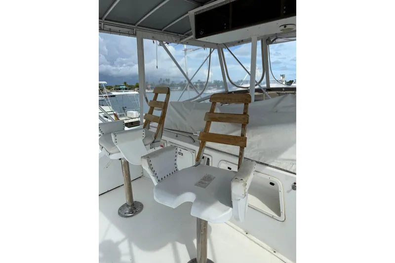 Slide: The Image of Captain's chairs on 1984 Bertram 46 Convertible yacht, overlooking marina. - 5