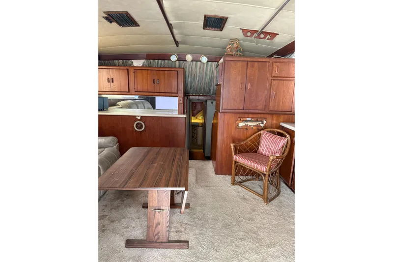Slide: The Image of Interior of 1984 Bertram 46 Convertible yacht with wooden cabinets and seating area. - 7