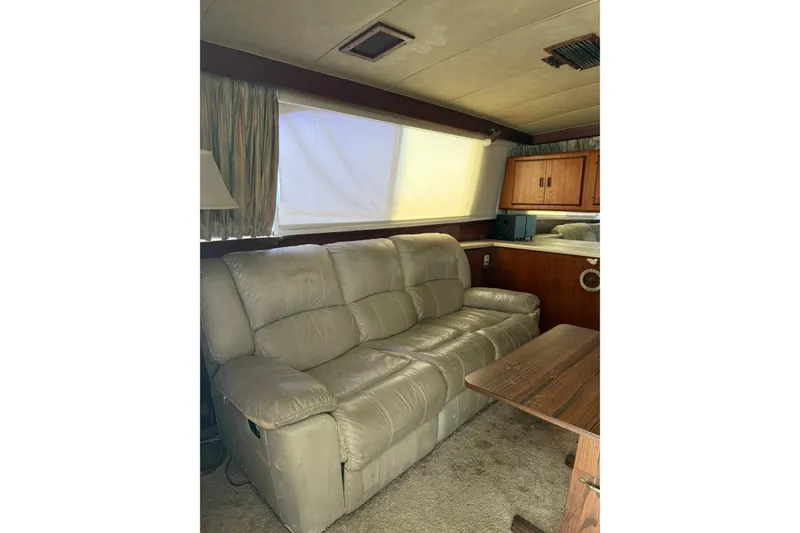 Slide: The Image of Interior of 1984 Bertram 46 Convertible yacht with beige leather sofa and wooden cabinetry. - 8