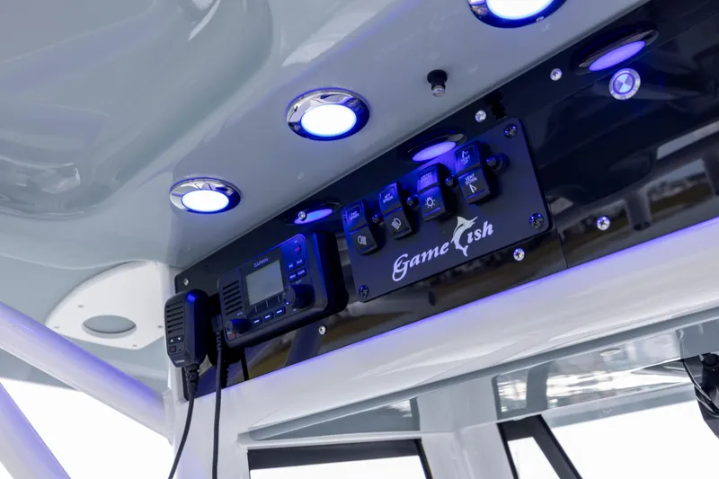 Slide: The Image of 2021 Sea Hunt Gamefish 25 boat console with illuminated controls and electronics. - 13